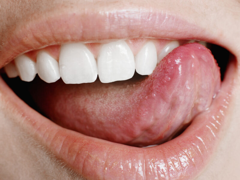 Young Woman Licking Lips, Close Up Of Mouth